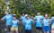 Team of young and diversity volunteer worker group enjoy charitable social work outdoor in mangrove planting project wearing blue