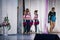 Team of young girls - athletes are preparing for the show, many young cheerleaders are standing on stage behind the curtain, sport