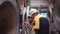 A team of young men working in a warehouse storing rolls of metal sheets.