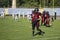 Teams for American football against the backdrop of a green field.