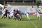 Teams for American football against the backdrop of a green field.