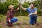 Teamwork, agriculture and collaboration high five farmer couple planting organic crops while bonding. Sustainability