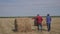 Teamwork agriculture smart farming concept. two men lifestyle farmers workers walking studying a haystack in field on