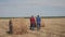 Teamwork agriculture smart farming concept. two men lifestyle farmers workers walking studying haystack in field on