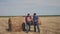 Teamwork agriculture smart farming concept. two men workers farmers walking studying haystack in field on digital tablet