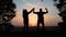 Teamwork. business a journey concept win. happy family team tourists man and woman sunset silhouette hands up teamwork