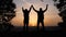 teamwork. business a journey concept win. happy family team tourists man and woman sunset silhouette hands up teamwork