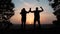 teamwork. business a journey concept win. happy family team tourists man and woman sunset silhouette hands up teamwork