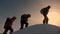 Teamwork of business people. three climbers climb one after another on a snow-covered hill. team of business people go