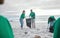 Teamwork, charity and recycling with people on beach for sustainability, environment and eco friendly. Climate change