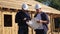 Teamwork. concept building constructing architect slow motion video. two men builder in helmets study the house plan