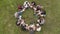 Teamwork concept. A group of high school students sit on the grass in a circle. Drone view.