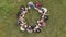 Teamwork concept. A group of high school students sit on the grass in a circle and scatter in different directions