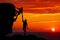 Teamwork couple hiking help each other trust assistance silhouette in mountains, sunset. Teamwork of man and woman hiker helping e