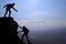 Teamwork couple hiking help each other trust assistance silhouette in mountains, sunset. Teamwork of man and woman hiker helping e