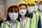 Teamwork engineering in uniform wear hardhat and protection mask at workshop industrial factory. worker professional manufacturing