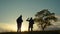 Teamwork. group two men silhouette hikers with backpacks walk along trail next go travel to the mountains up top near