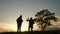 Teamwork. Group two men silhouette hikers with backpacks walk along trail next go travel to the mountains up top near