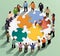 Teamwork isometric concept. Group of business people holding puzzle pieces.