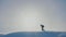 Teamwork. Men tourists climbing walking top mountains rocks peak group team sunlight silhouette on snow feet winter
