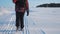 Teamwork. men tourists photographers go on snow in winter with a tripod climbing walking top mountains rocks peak group