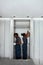 Teamwork and professional cooperation concept. Man and woman installing bedroom closet