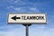 Teamwork road sign, arrow on blue sky background