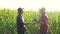 Teamwork smart farming husbandry concept slow motion video. two men agronomist two farmers victory shake hands teamwork