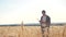 Teamwork smart farming slow motion video. farmer work in wheat field. farmer explore are studying. man with digital