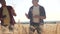 Teamwork smart farming slow motion video. two farmers work in wheat field. farmers explore are studying. man with