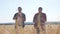 Teamwork smart farming. two farmers work in wheat field. farmers explore are studying. man with digital tablet Wheat