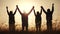 Teamwork. team community hold hands together silhouette at sunset unity. Group of people hands. Teamwork a workers carry