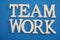 Teamwork text letters alphabet on blue background