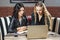 Teamwork. Two smiling young business women sitting in office at table and working. Students learning online, chatting. Brainstormi