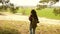 Teamwork Woman traveler walking in forest with backpack and a dog. Hiker Girl raises her hand up, celebrating victory