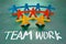 Teamwork words and colorful paper dolls