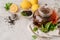 Teapot with black tea decorated with mint leaves, lemons and dry tea leaves