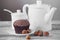 Teapot, chocolate cupcakes, nuts and different decorations