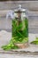 A teapot with mint tea and a mug on a wooden background.A soothing, healthy drink.Summer tea