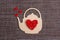 Teapot symbol with red hearts on sackcloth background. Valentine`s day concept