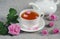 Teapot and tea cup with rosebuds