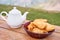 Teapot with tea and delicious National Kazakh pastries baursak. Street cafe in the highlands with a view of the