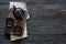 Teapot, teacup and Rooibos tea over black wood background