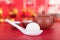 Teapots and bowls on a festive red background and spoons with dumplings