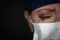 Tearful Stressed Female Doctor or Nurse Crying Wearing Medical Face Mask on Dark Background