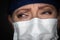 Tearful Stressed Female Doctor or Nurse Crying Wearing Medical Face Mask on Dark Background