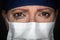 Tearful Stressed Female Doctor or Nurse Crying Wearing Medical Face Mask on Dark Background