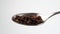 Teaspoon with dried instant chicory root granules containing inulin. Fall in slow motion