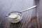 Teaspoon with sweet condensed milk and small bowl