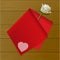 Teat towel folded on a rose on wood background